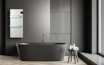 A matte black freestanding bathtub sits in a modern minimalist bathroom with a white wall-mounted towel warmer and elegant herringbone wood floors.