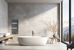 A sleek grey wall-mounted glass towel heater warms a minimalist bathroom featuring a white oval freestanding bathtub and a floor-to-ceiling window overlooking a snowy mountain landscape.