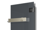 A sleek wall-mounted grey glass heater displays a digital temperature reading and features a modern gold towel rack.